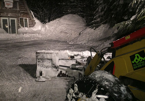backhoe removing snow